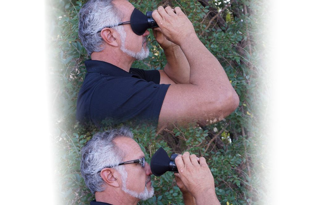   A man looking through binoculars showing the effectiveness of glare reduction with a product called the Bino Bandit.