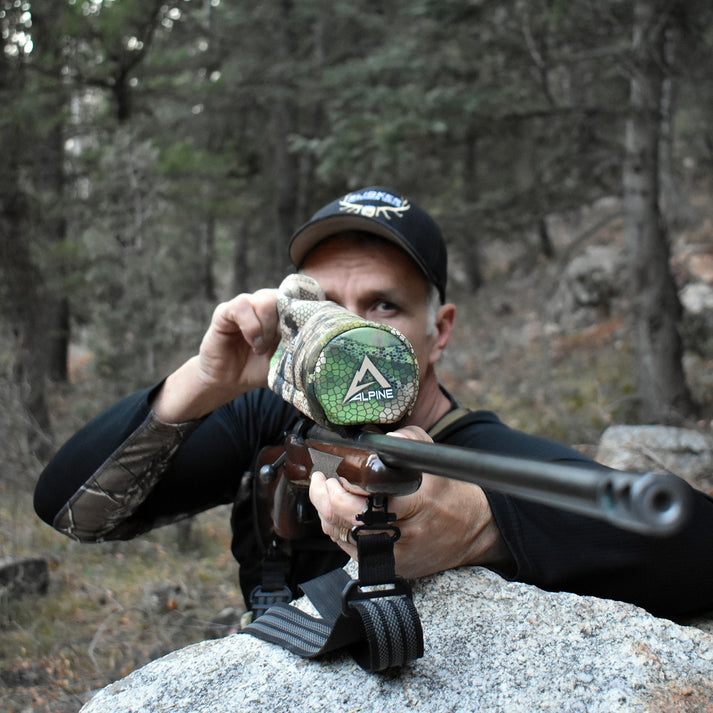Hunter using a rifle with a Scope Cover NX2
